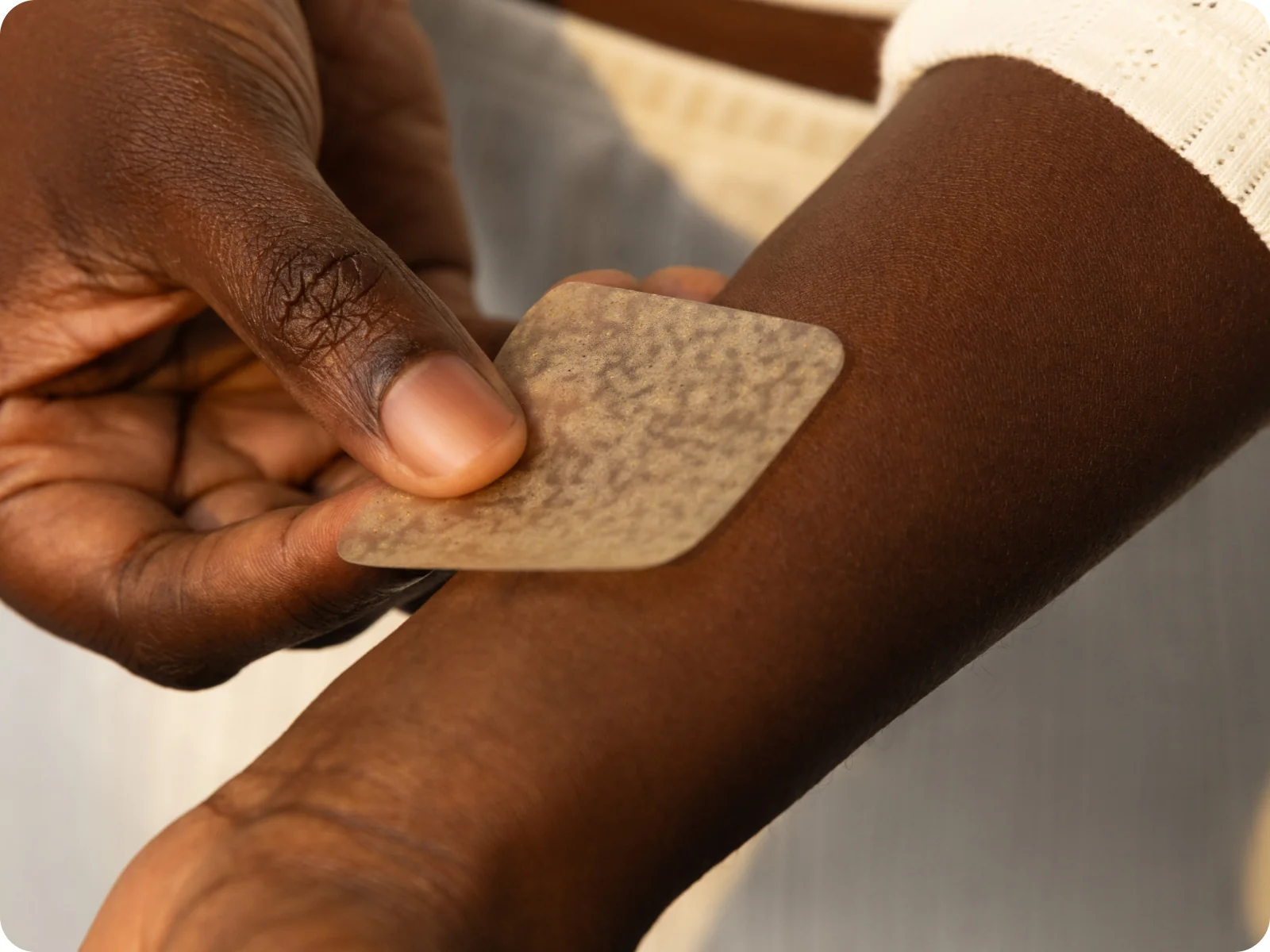 Applying a wellness patch to the forearm