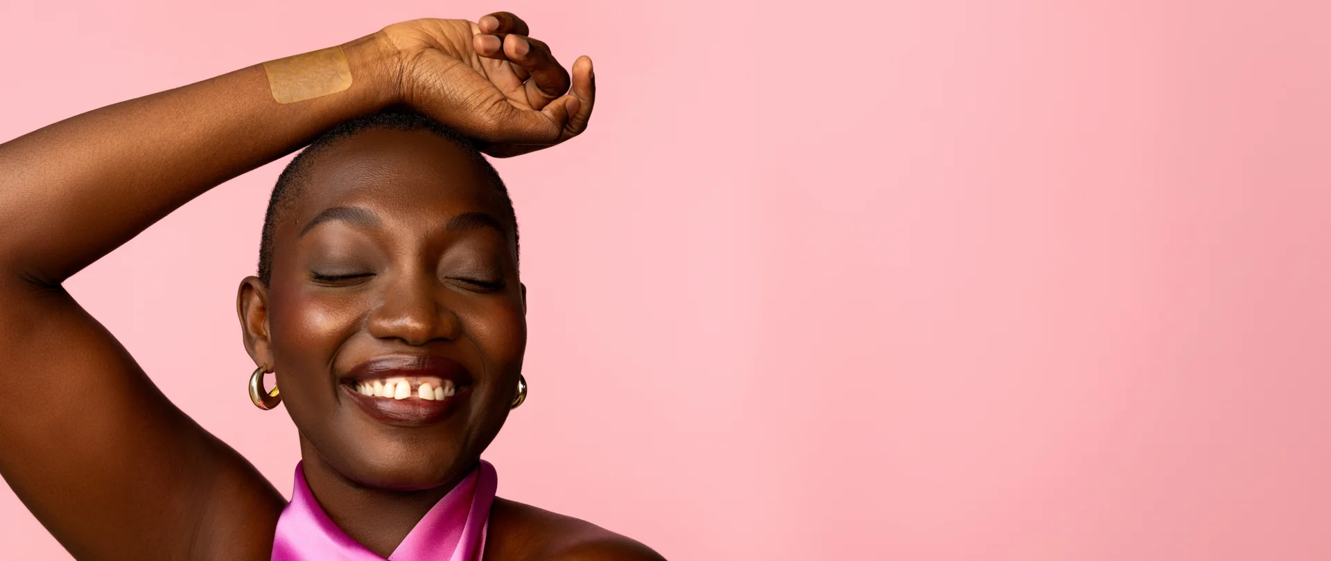Woman smiling with a patch on her wrist